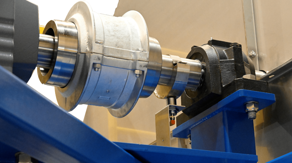 Cross-Belt Sampler (CBS) machine extracting material sample from conveyor belt in an industrial setting